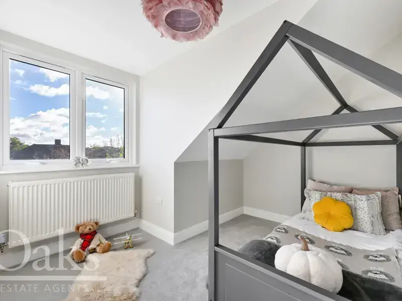 Bright children’s bedroom with roof-style bed and large window at Byards Croft, Dion Homes.