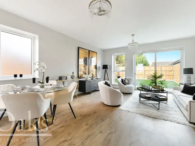 Open-plan living and dining area with wooden floors and large patio doors at Byards Croft, Dion Homes.