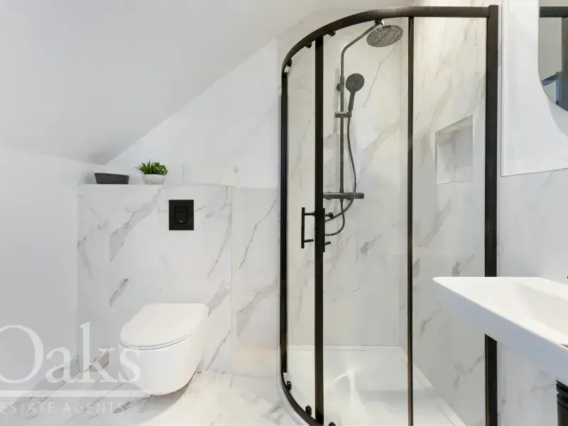Elegant bathroom with walk-in shower and marble-style tiles at Byards Croft, Dion Homes.
