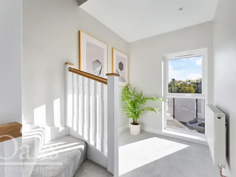 Bright hallway with natural light and white interior at Byards Croft, Dion Homes.