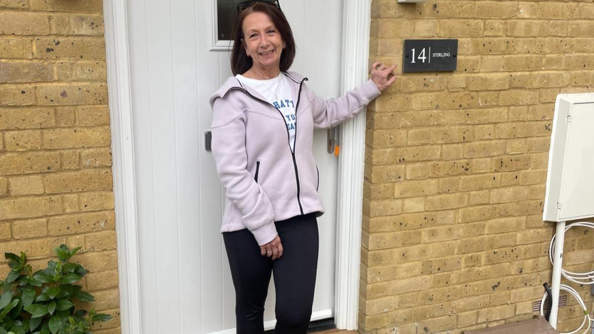 New homeowner standing at front door at Oakley Gardens, Redhill