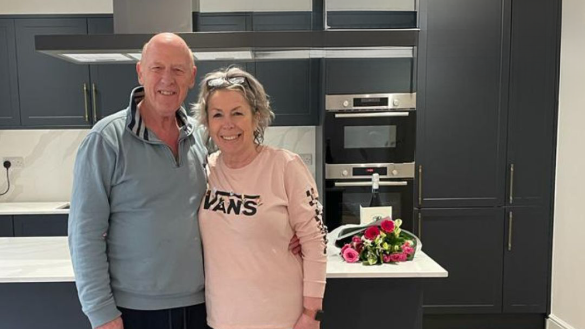 Happy homeowners in modern kitchen at The Meadow of Oaks