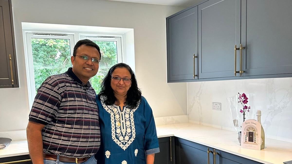 Happy homeowners in their new Dion Carshalton kitchen on Blossom Way, Carshalton