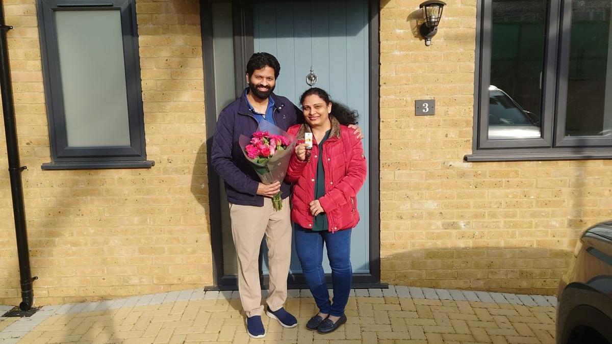 Family standing outside their newly built home at Blossom Way after completing their purchase.