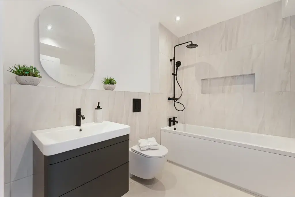 Contemporary family bathroom with bathtub and premium fittings in a newly built home in South London.