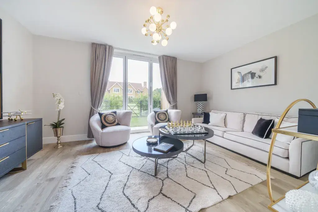 Elegant living room with large windows and open-plan layout in a modern new build home.